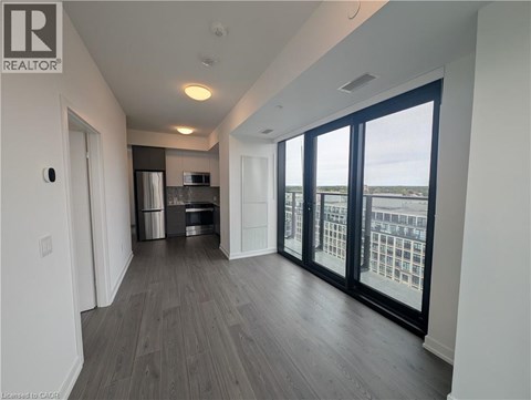 A spacious room with a view of the city through large windows.