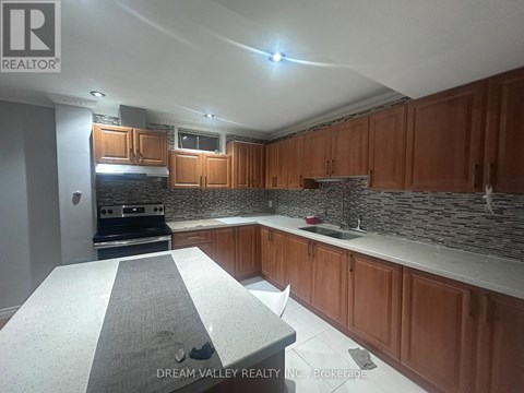 A kitchen with wooden cabinets and a granite countertop.