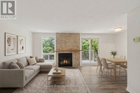 A living room with a fireplace and a dining table.