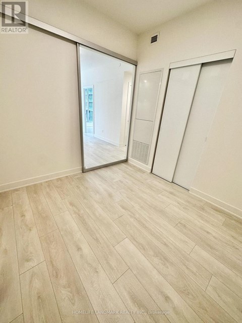 A room with a sliding door and wooden flooring.