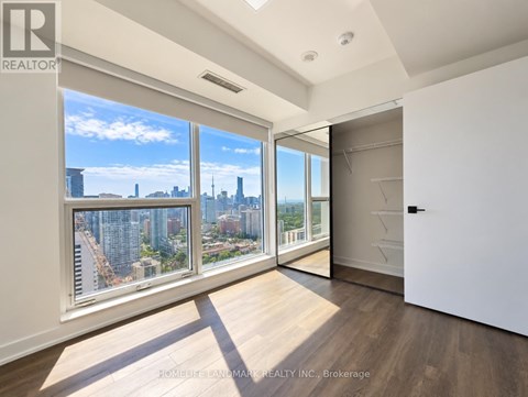 A well-lit, spacious room with a view of the city skyline.