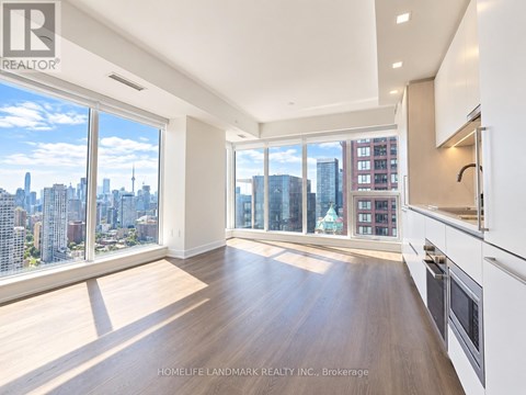 A spacious kitchen and living room with a view of the city skyline.