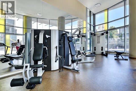 A gym with a variety of equipment including a treadmill, weights, and a bench press.