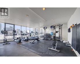 A gym with a variety of equipment including treadmills, weights, and exercise machines.