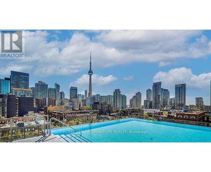 A pool on a balcony with a city skyline in the background.