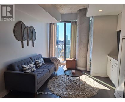 A living room with a grey sofa and a coffee table.