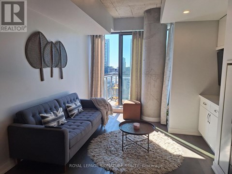 A living room with a grey sofa and a coffee table.