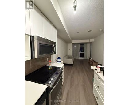 A kitchen with a stove top oven and microwave.