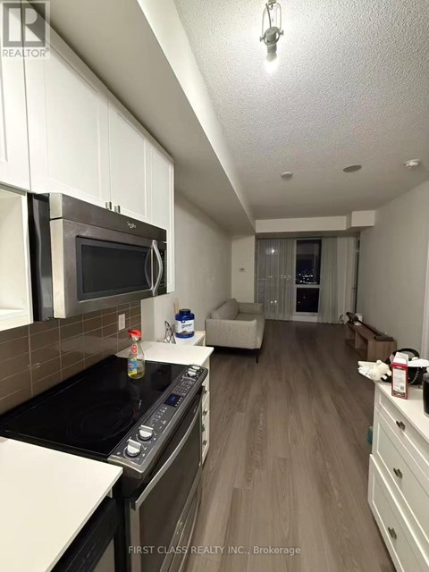 A kitchen with a stove top oven and microwave.