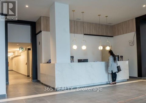 A woman stands at the front desk of a realty office.