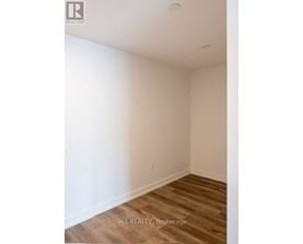 A room with a wooden floor and white walls.