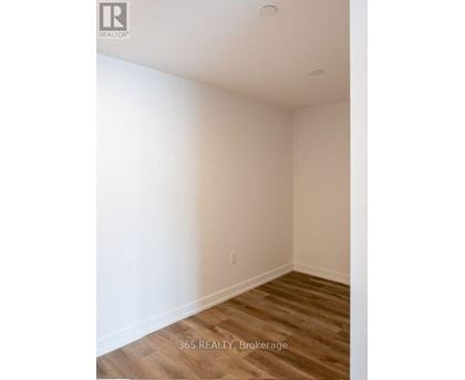 A room with a wooden floor and white walls.