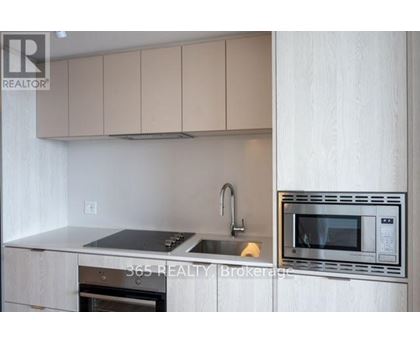 A modern kitchen with a stainless steel oven and microwave.