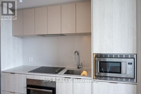 A modern kitchen with a stainless steel oven and microwave.