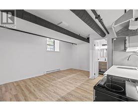 A kitchen area with a stove top oven and a sink.