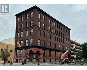 A large red brick building with a crane in front of it.