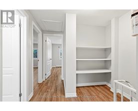 A white room with a wooden floor and a white door.