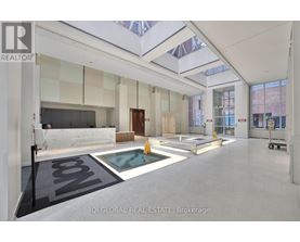 A spacious real estate brokerage office with a pool table and a glass ceiling.