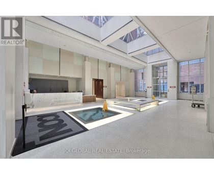 A spacious real estate brokerage office with a pool table and a glass ceiling.