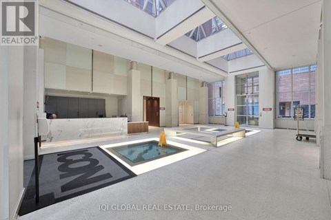 A spacious real estate brokerage office with a pool table and a glass ceiling.