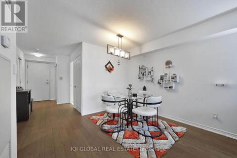 A dining room with a white table and chairs.