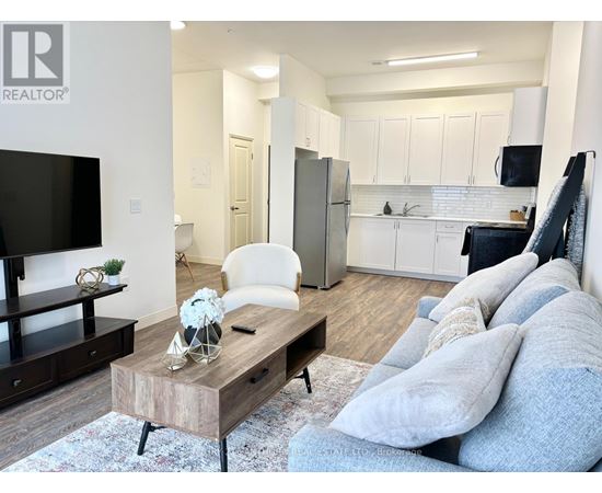 A living room with a white couch and a wooden coffee table.