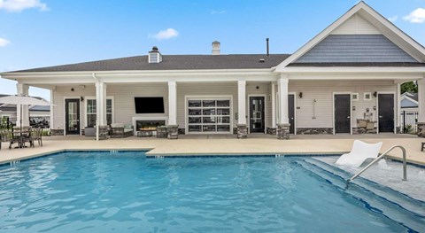 A house with a pool in front.