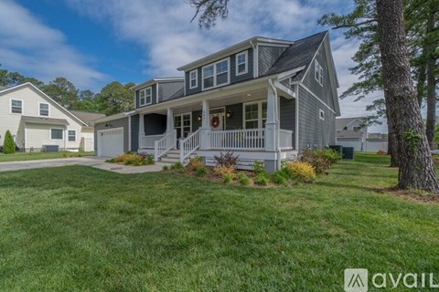 A house with a grey and white exterior is available for sale.