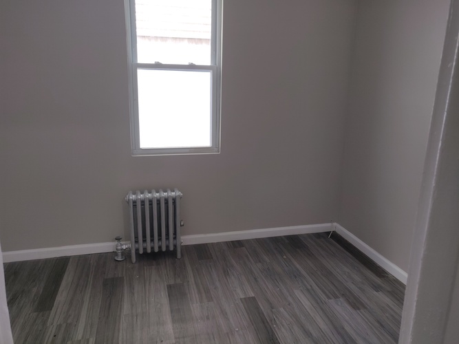 A room with a radiator and a window.