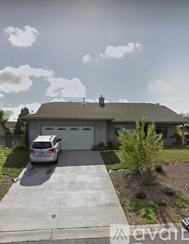 A house with a car parked in front of it.
