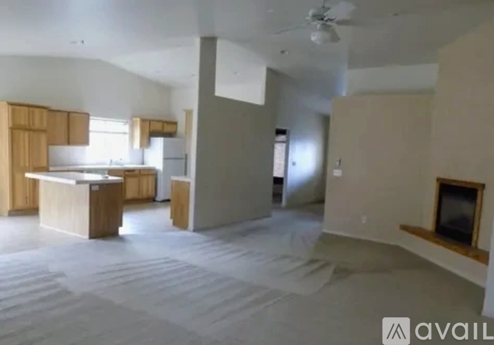 A room with a kitchen area and a living room area.