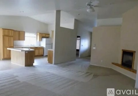 A room with a kitchen area and a living room area.