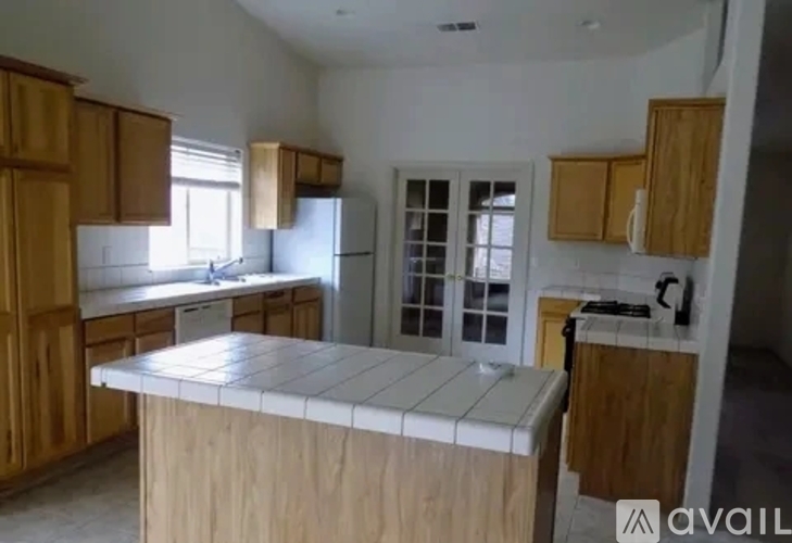 A kitchen with wooden cabinets and a white refrigerator.
