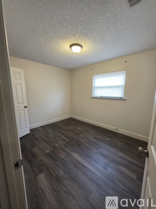 A room with a window and a door.