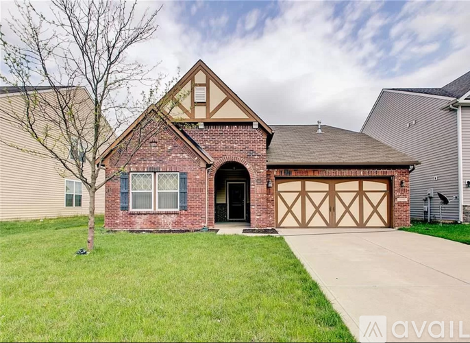 A house with a brick facade and a large garage door.