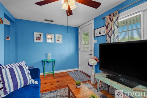 A living room with a blue couch and a television.