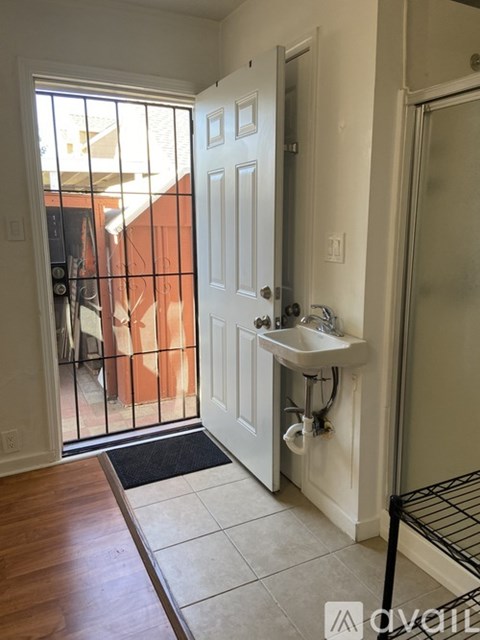 A bathroom with a white sink and a white door.
