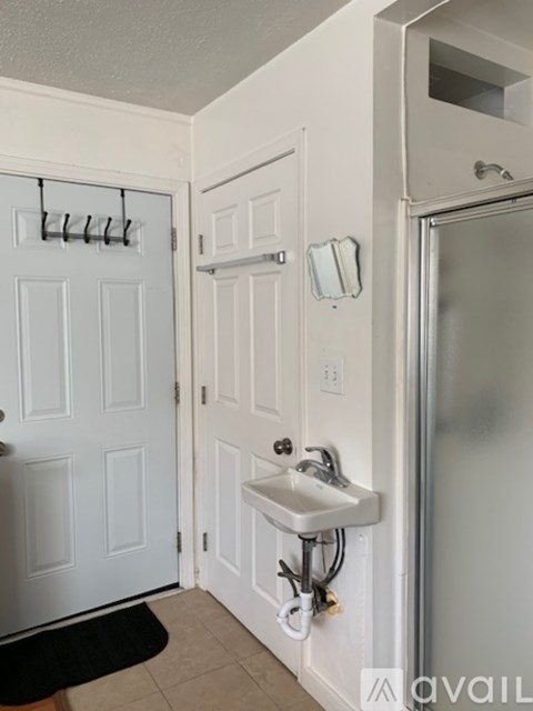 A bathroom with a sink and a shower.