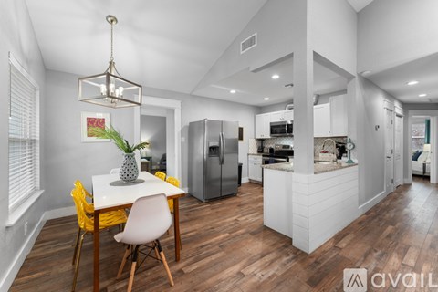 A modern kitchen with a dining table and chairs.