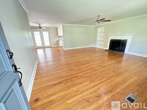 A room with wooden floors and a fireplace.