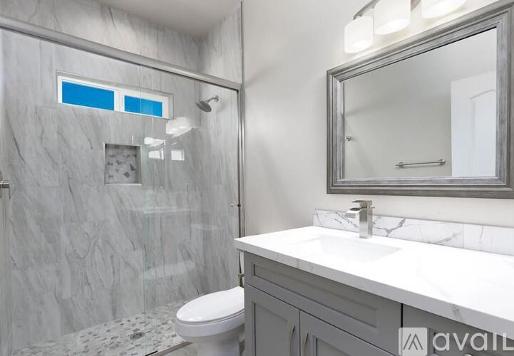 A bathroom with a marble toilet and sink.