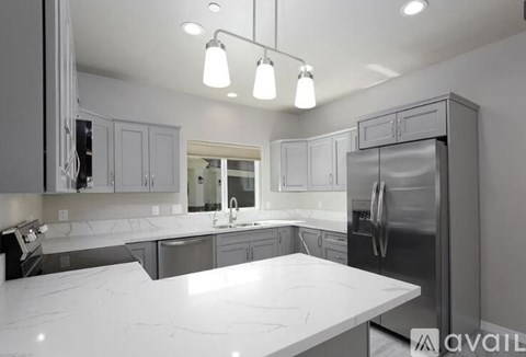 A modern kitchen with a large island in the center.