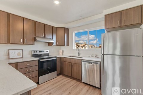 A kitchen with wooden cabinets and stainless steel appliances.