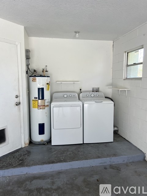 A white washer and dryer in a small utility room.
