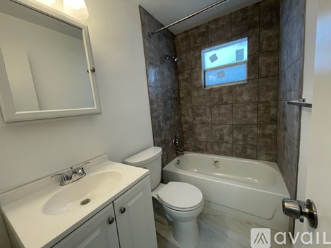 A bathroom with a white toilet, sink, and bathtub.
