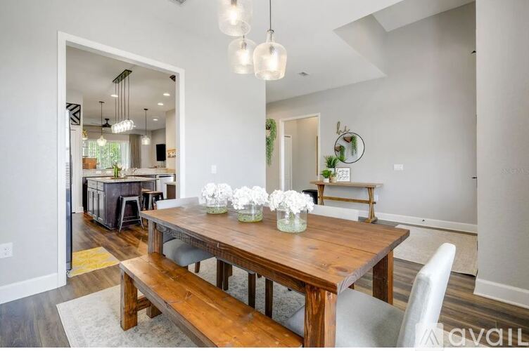 A dining room with a wooden table and chairs.