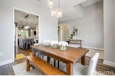 A dining room with a wooden table and chairs.