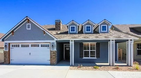 A house with a garage and a driveway in front.