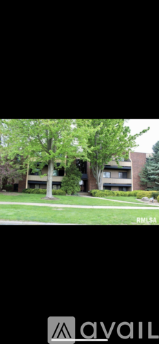 A building with a green lawn in front of it.