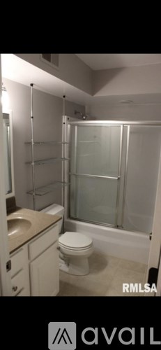 A bathroom with a toilet, sink, and shower.